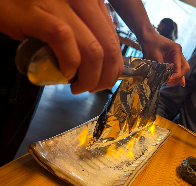 tableside flaming of softshell crab roll at sibuya urban sushi bar