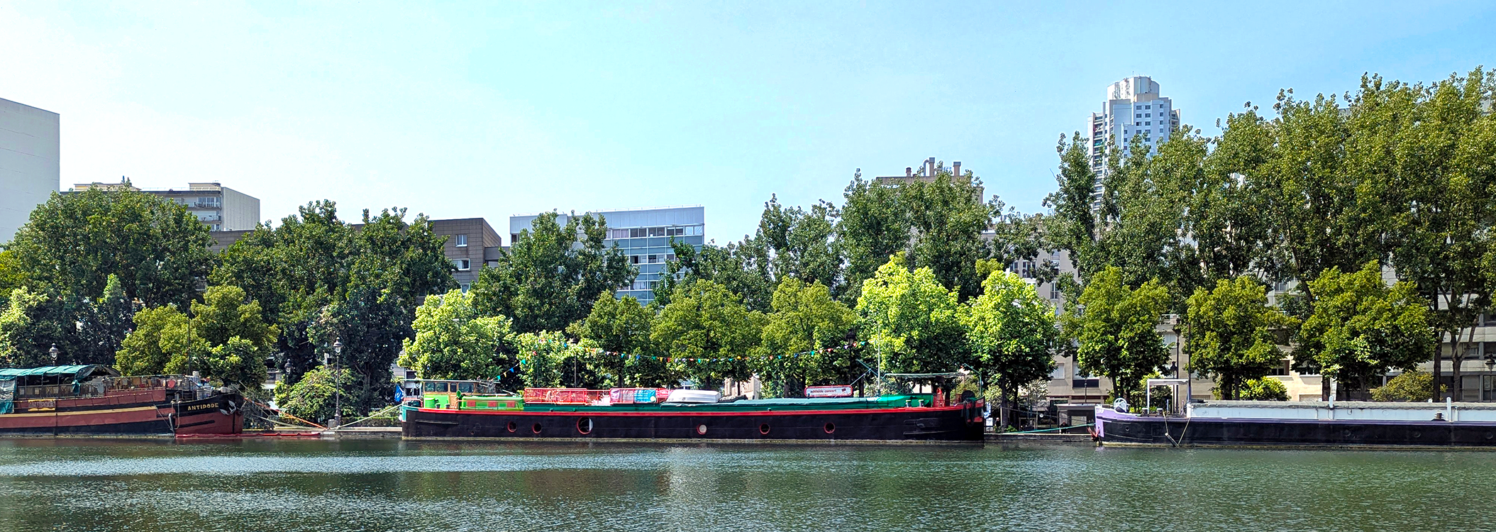 colorful barge along the ourcq canal in paris