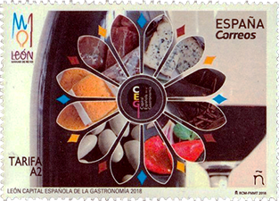 A colorful Spanish postage stamp featuring a flower design made of various food items, celebrating León as the Capital of Gastronomy in 2018.