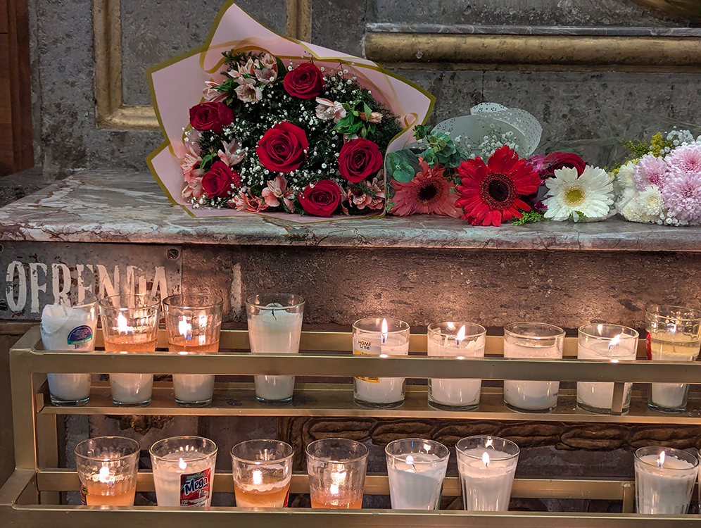 flowers and votive candles in Basilica of Our Lady of Zapotan