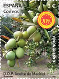 A Spanish postage stamp featuring green olives and the text 'D.O.P. Aceite de Madrid', highlighting the gastronomy of the region.